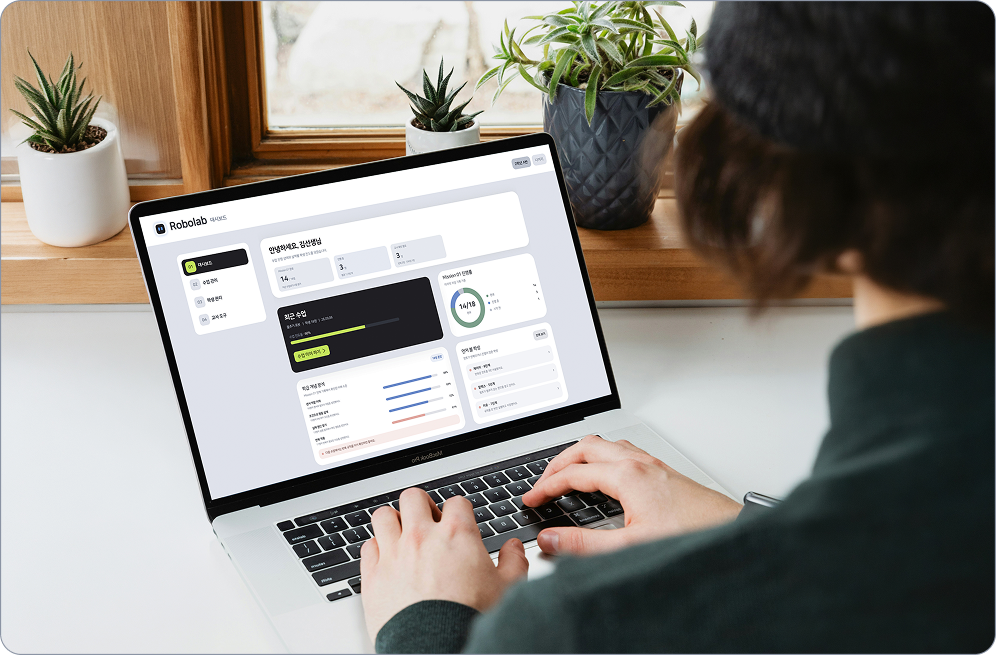 An educator reviewing the RoboLab class dashboard on a laptop