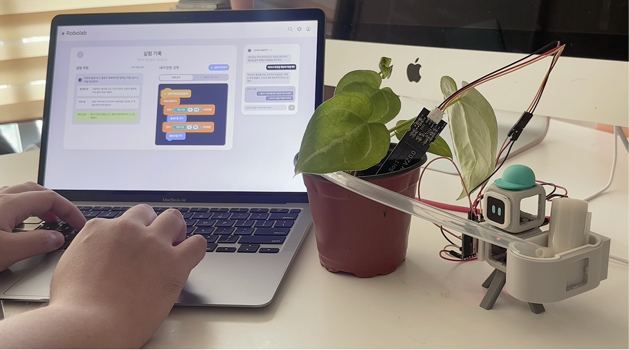A physical watering robot connected to a real plant and companion web experiment history